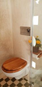 a bathroom with a toilet with a wooden toilet seat at The Rooftop in Essaouira