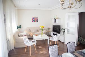 een woonkamer met een bank, een tafel en stoelen bij Casa La Fuentecilla in Consuegra