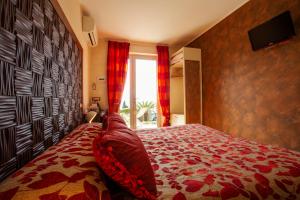 a bedroom with a large bed with a red blanket at B&B Il Parco in Monterosso al Mare