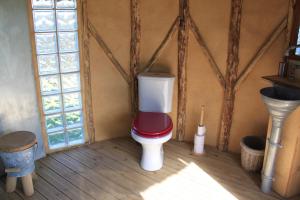 a bathroom with a toilet in a room with windows at Terragora Lodges - Hébergement atypique in Les Épesses