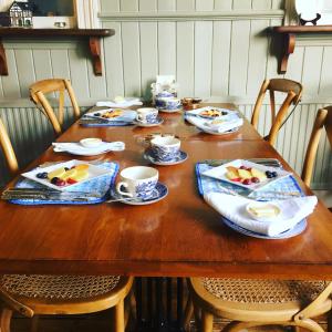 a wooden table with plates of food on it at The Old Railway Station in Petworth