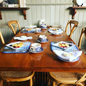 una mesa de madera con platos de comida. en The Old Railway Station, en Petworth