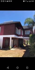 a large red house with a tree in front of it at MAU-MAR in Colón