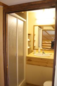 a bathroom with a shower and a sink and a mirror at Groc Fluvia in Barcelona