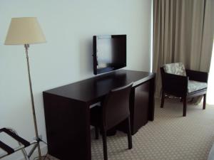 
A television and/or entertainment center at Elegance Hotel

