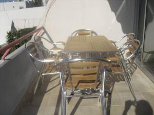 a table and chairs sitting on a balcony at Amathusia beach apartment in Limassol