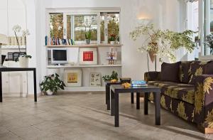 a living room with a couch and a table at Hotel La Tosca in Capri +8 photos