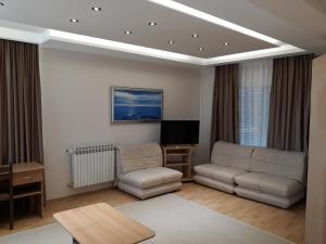 a living room with two couches and a tv at Motel Lav in Čapljina