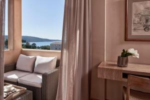 a living room with a couch and a window at The Margi in Athens