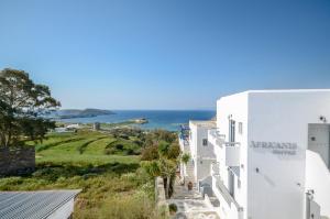 a view of the ocean from the side of a building at Africanis Suites in Schinoussa