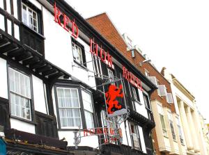 a red brick building with a sign on the side of it at Brook Red Lion Hotel in Colchester