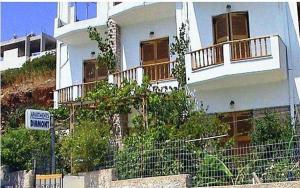 a white building with balconies on the side of it at Diamont Studios in Agia Galini