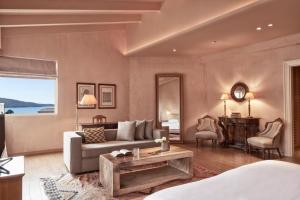 a living room with a couch and a table at The Margi in Athens
