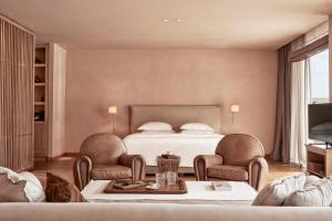 a bedroom with a bed and two chairs and a table at The Margi in Athens