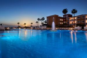 
a large pool of water in front of a large building at Gran Meliá Sancti Petri in Chiclana de la Frontera
