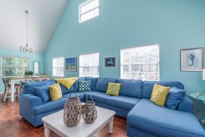 a blue living room with a blue couch at Seawalk Cottage in Tybee Island