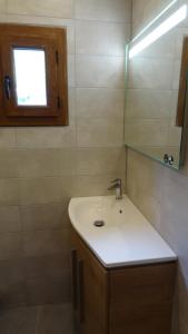 a bathroom with a sink and a mirror at La Marmotte de la Tour in Hermillon