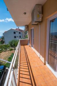 a balcony with a view of the ocean at APARTMAN KSENIJA KOVAČIĆ in Stanići