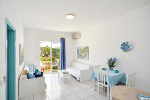 a living room with a table and a couch at Marika Studios & Apartments in Georgioupolis