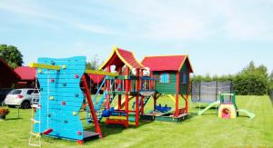 a group of playground equipment in a field at Domki Letniskowe WIKTORIA in Jezierzany