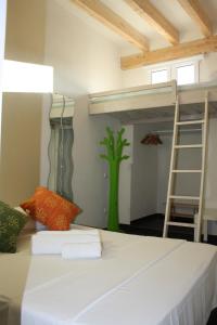a bedroom with a bunk bed and a ladder at Santa Barbara Guesthouse in Alicante