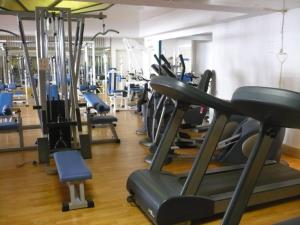 a gym with rows of treadms and pilates equipment at Grand Hotel Dei Cesari Dependance in Anzio