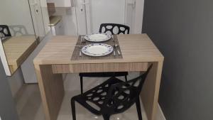 a wooden table with two plates on top of it at Apartman SIRIUS in Osijek