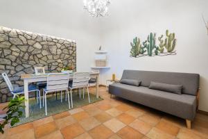 a living room with a couch and a table at Nonna Carmela Apartment in SantʼAgata sui Due Golfi