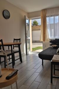 a living room with a table and a dining room at Alka in Mielno