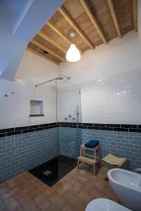 a bathroom with a shower and a toilet and a sink at CASA AMARELA in Avis
