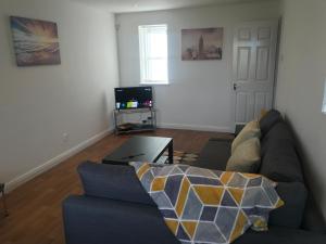 a living room with a couch and a table at Kingsway Court in Liverpool
