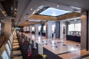 a conference room with a long table and white chairs at Gran Hotel Luna de Granada in Granada +79 photos