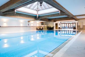 einem großen Pool in einem Gebäude mit Glasdecke in der Unterkunft Solent Hotel and Spa in Fareham