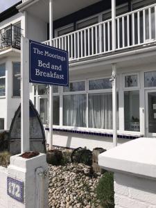 a sign in front of a house with a bed and breakfast at The Moorings B&B in Southend-on-Sea