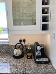 a kitchen counter with a toaster and a blender at 3A Mellon Udrigle in Obinan