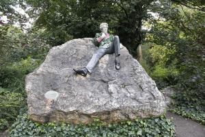 a statue of a man sitting on a rock at Jurys Inn Dublin Parnell Street in Dublin