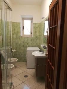 a bathroom with a toilet and a sink and a shower at IL CONTE DI MARRAONE in Agnone +41 photos