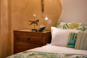 a bedroom with a bed and a lamp at Palazzo Marziale in Sorrento