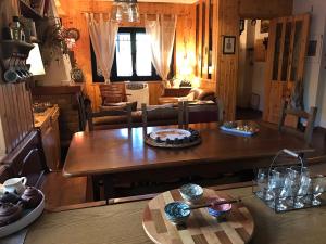a kitchen and living room with a wooden table at Casa Marida in Camigliatello Silano
