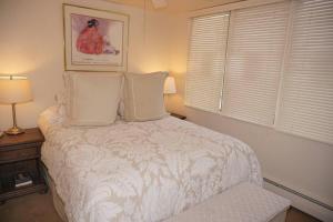 a bedroom with a white bed with two pillows at 520 Cooper Ave E #305 (203040-6863) Condo in Aspen