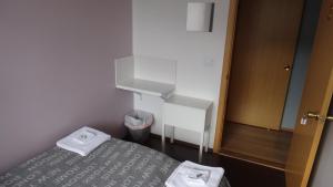 a small room with a bed with towels on it at Fjord Guesthouse in Súðavík +34 photos