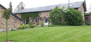 a brick house with a yard in front of it at Le Petit Lustucru in Saint-Martin-des-Champs