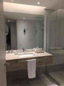 a bathroom with a sink and a shower and a mirror at Hotel Estelar Square in Medellín