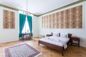 A bed or beds in a room at Barbo Palace Apartments and Rooms