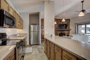 a kitchen with a stainless steel refrigerator and a living room at 303D Dillon Bay Condo Condo in Dillon