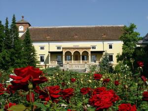 a house with red flowers in front of it at Pytloun Schlosshotel Weikersdorf in Baden