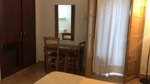 a room with a table and chairs and a mirror at Casa de Huespedes la Peña in Ibiza Town