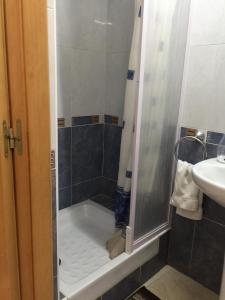 a bathroom with a shower with a tub and a sink at Hostal Mont Thabor in Barcelona