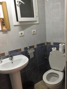 a bathroom with a toilet and a sink at Hostal Mont Thabor in Barcelona