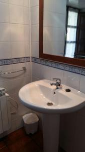 a bathroom with a white sink and a mirror at Casa Belarmina in Cangas de Onís +27 photos